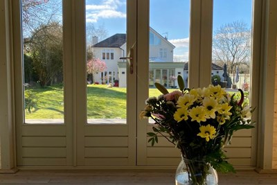 Outside view from garden room with table of flowers